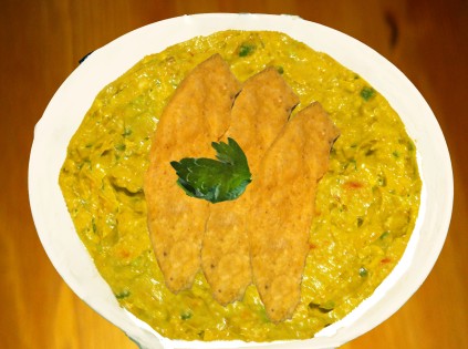 Image of Guacamole garnished with corn chips and cilantro